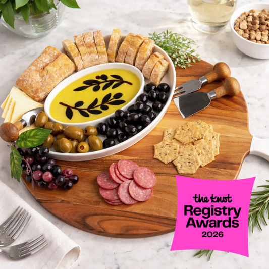 Wooden charcuterie board with cheese, olives, salami, and crackers on a marble surface, featuring 'The Knot Registry Awards 2026' badge.