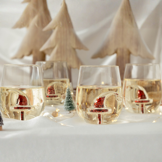 Wine glasses with Christmas decorations on a snowy background
