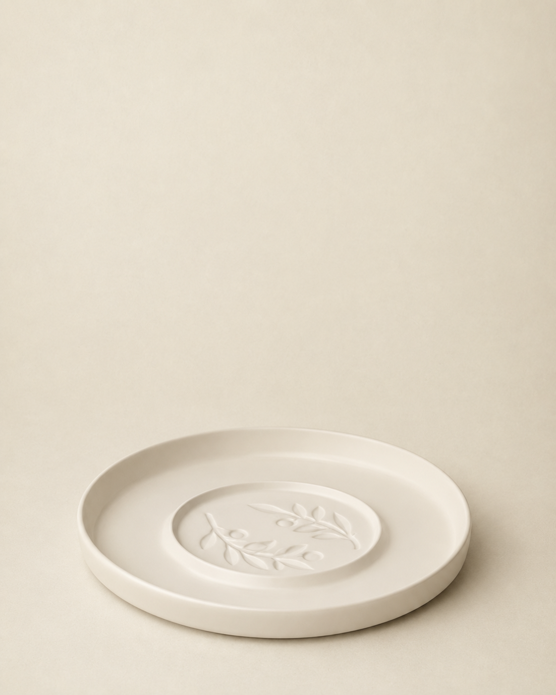Round olive brach dipping platter on a cream background